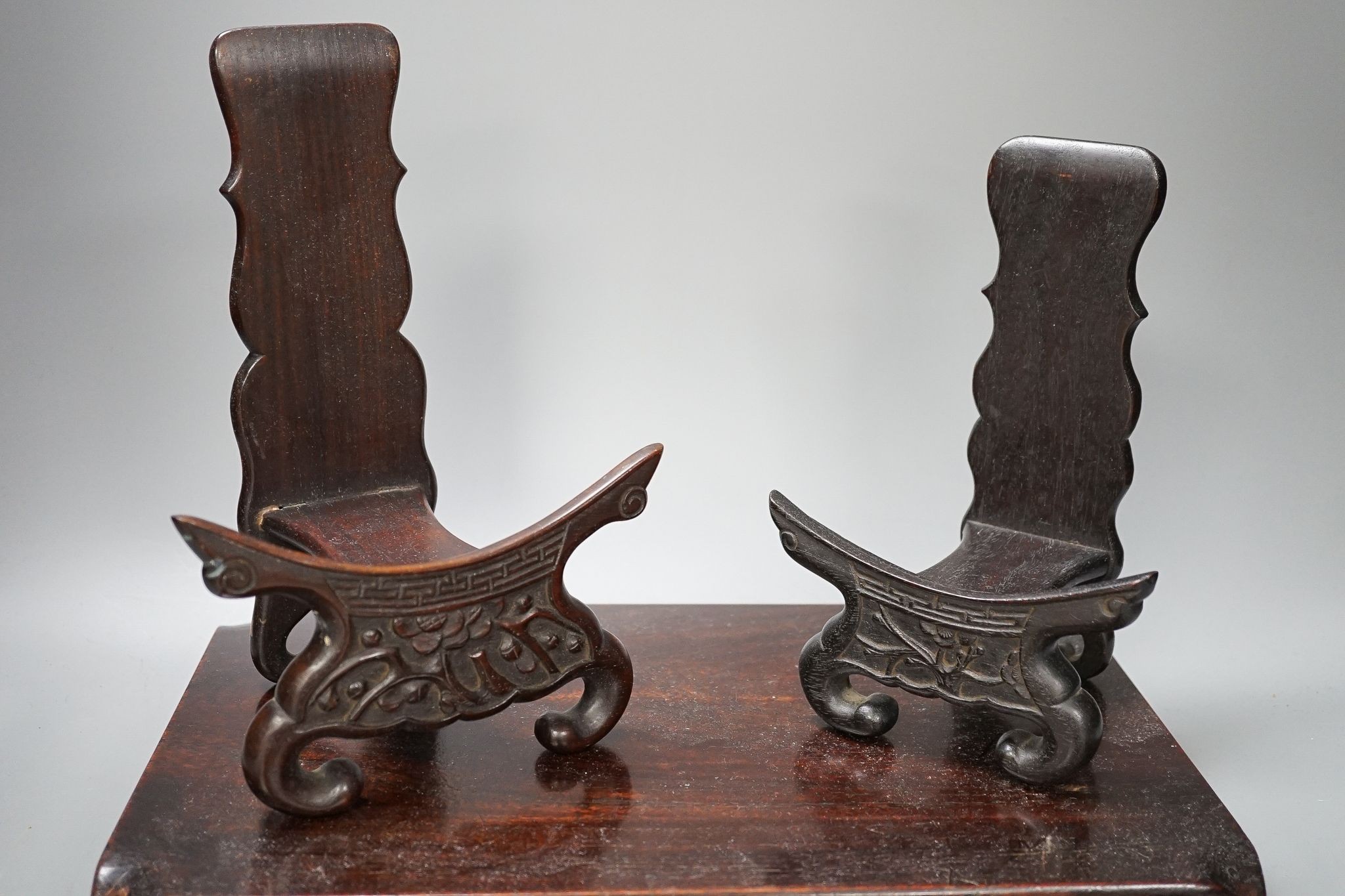 Two Chinese hardwood low stands and two similar plate stands, largest 36cm